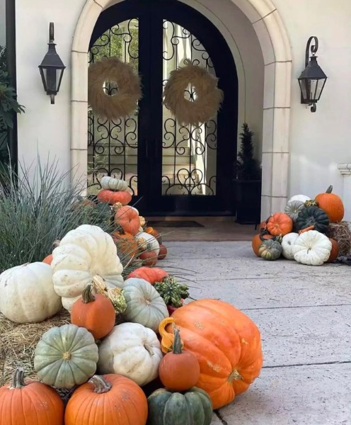 A porch styled with seasonal color and natural textures